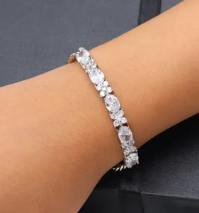 Silver-toned tennis bracelet featuring oval-cut sparkling zircon stones.