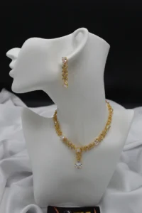 Floral motif necklace with zircon stones and matching dangle earrings, crafted in stainless steel for a lightweight, elegant look.
