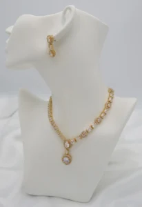 Elegant necklace with alternating oval and rectangular stones, central halo pendant, and matching oval drop earrings for a timeless look.