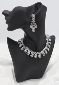 FAS jewelry set featuring an 8-inch necklace and matching drop earrings with rectangular gemstones in halo settings on gold-tone stainless steel.