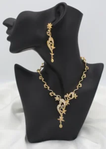 Floral vine necklace with teardrop pendant and matching dangling earrings in stainless steel.