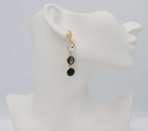 Gold-toned drop earrings with cascading clear, light green, and deep emerald crystals in a polished