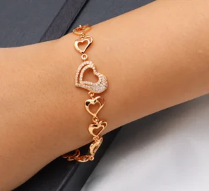 Gold-toned heart bracelet with zircon charm and adjustable fit.