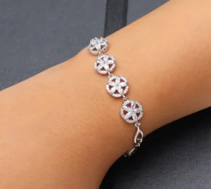 Silver-toned floral bracelet with zircon stones and adjustable fit.